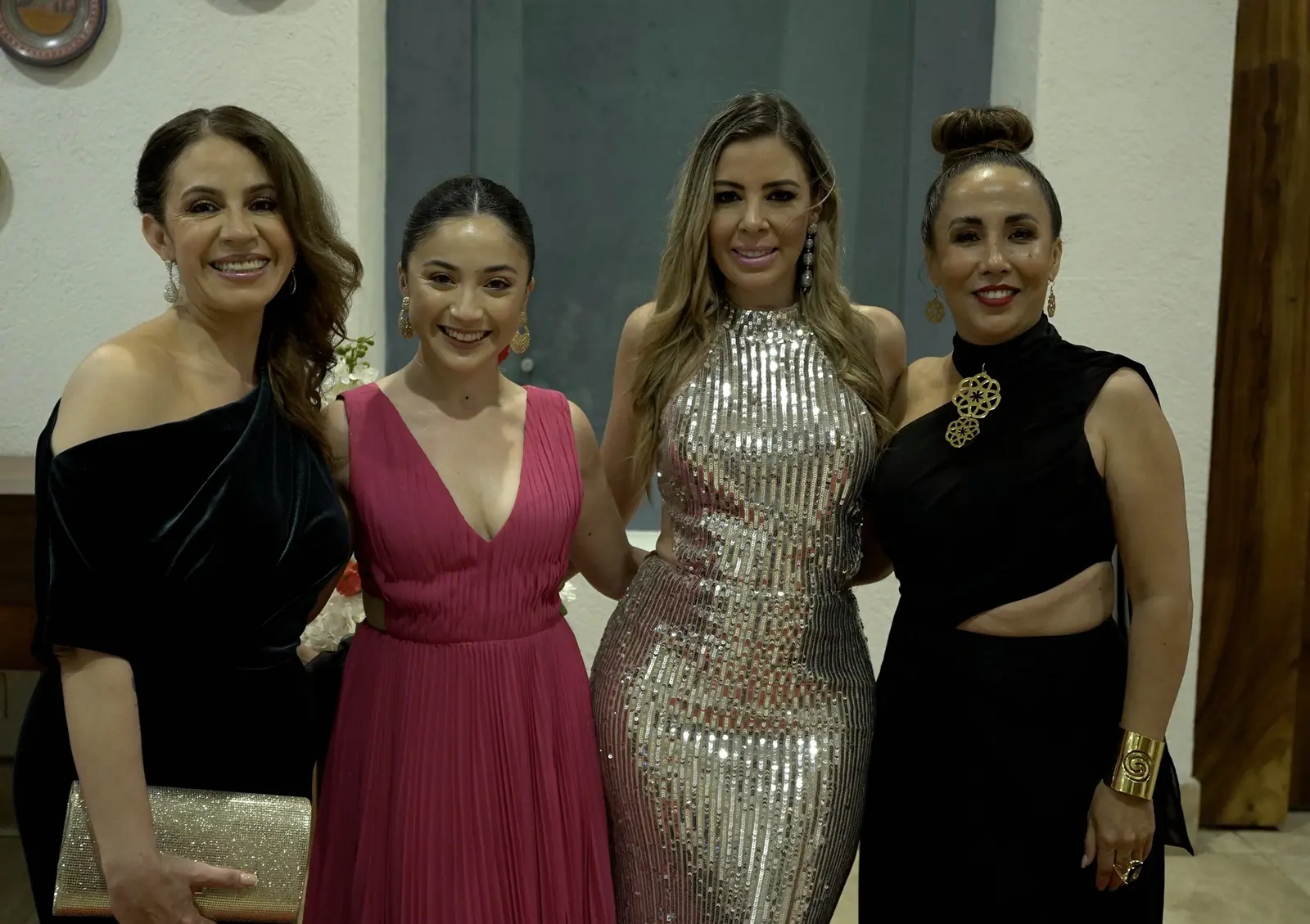 Cuatro integrantes en vestido de gala, abrazadas y sonriendo, al llegar a la cena de gala en Vallarta